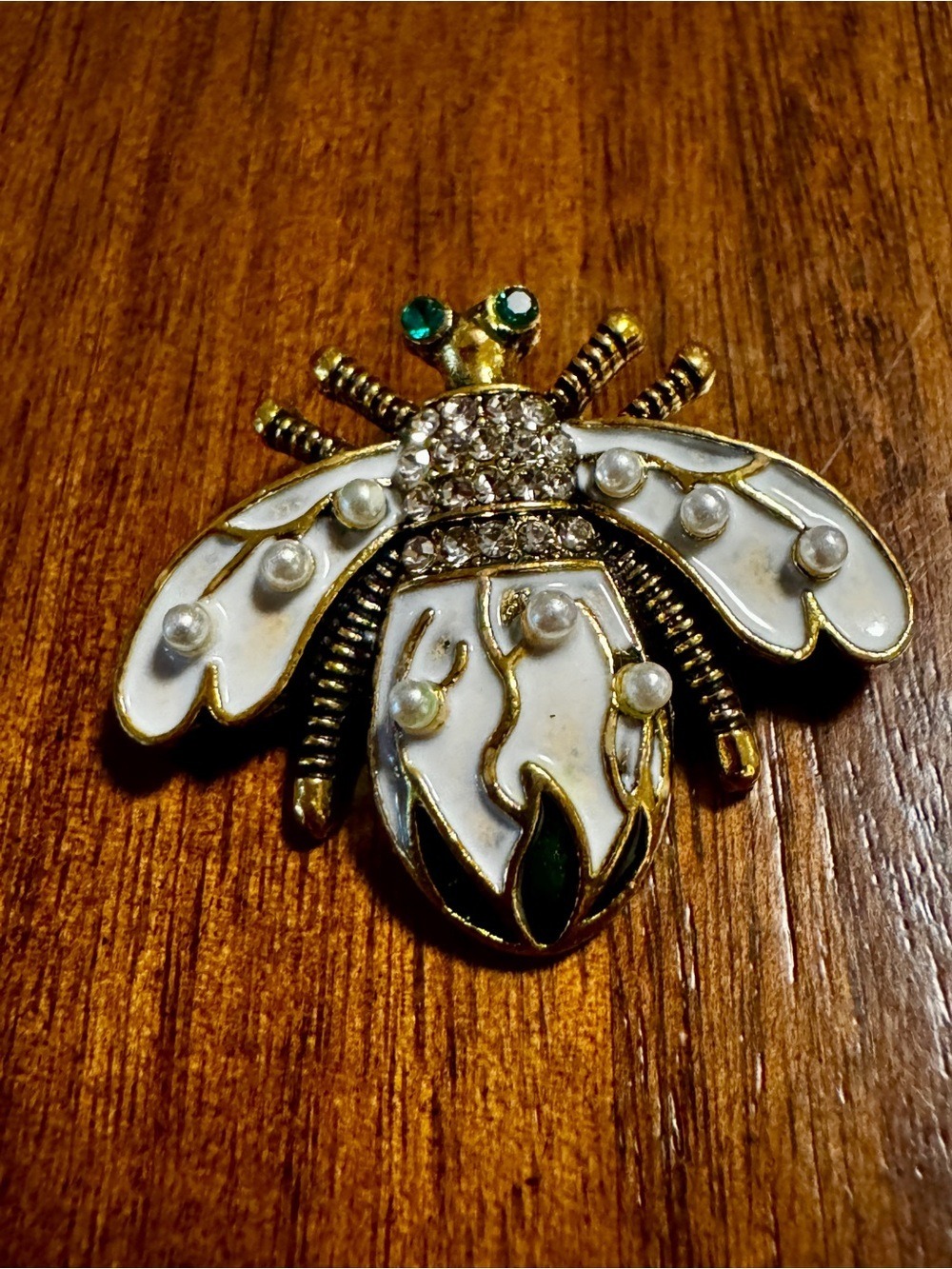 Gold Tone Bee Brooch with White Enamel and Green Accents